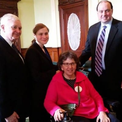Four people pose at the AHVP Briefing at the State House.