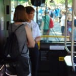Person speaks to a bus driver.