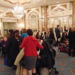 Attendees in the ballroom conversing over refreshments.