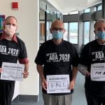 Three people wearing black ADA 30 t-shirts and facial masks hold signs that read DISABILITY DISCRIMINATION IS DONE! and AN ACCESSIBLE WORLD IS FREE and FOR ALL.
